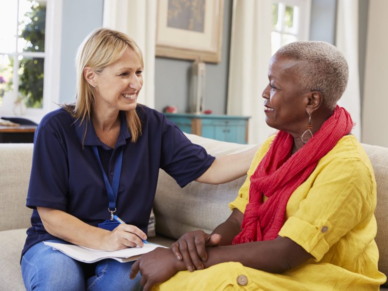 Female Support Worker Visits Senior Woman At Home